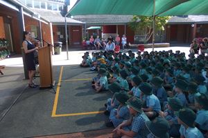 Nas speaking to student at assembly