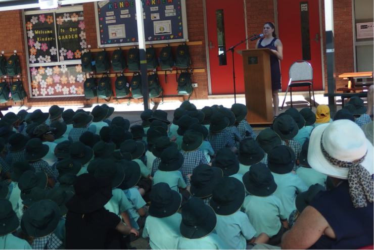 Nas speaking in front of the whole school assembly.
