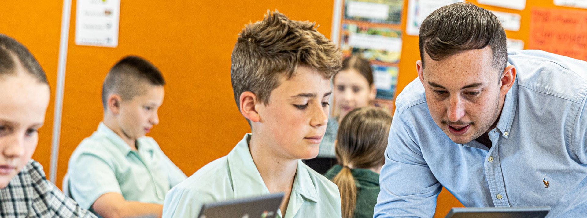Teacher helping students at Our Lady of the Way Catholic Primary Emu Plains