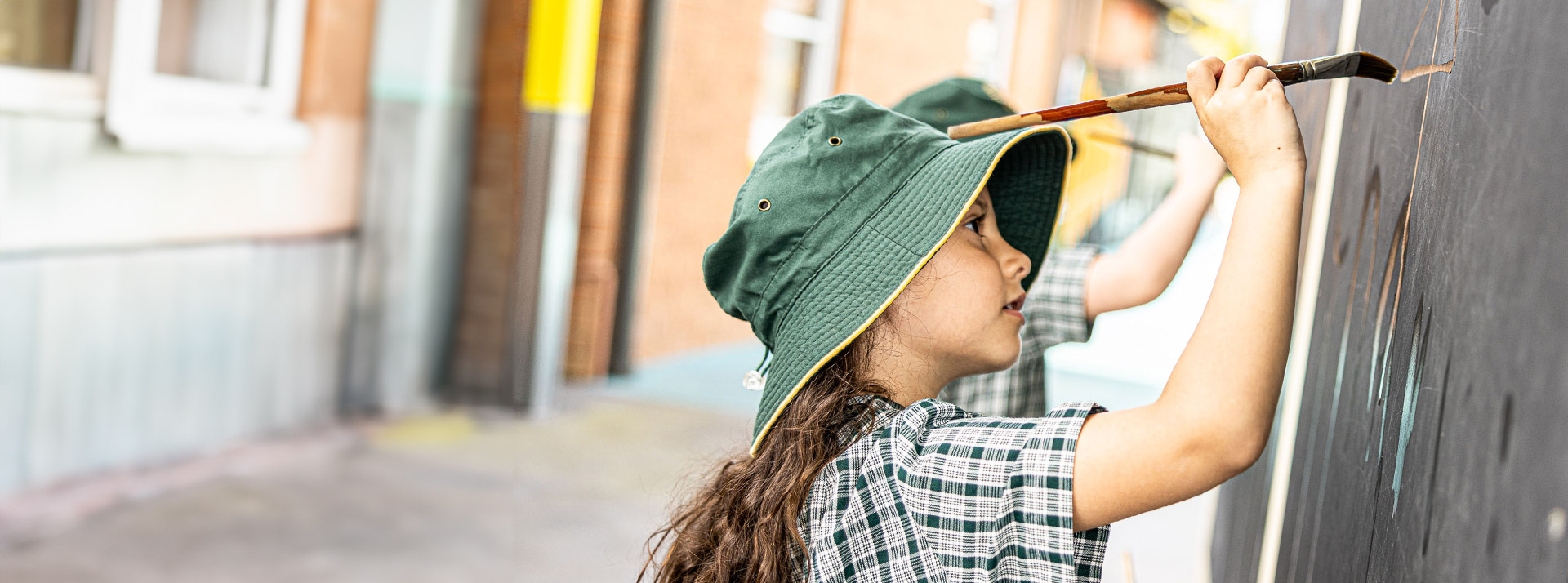 Students paining outdoors at Our Lady of the Way Catholic Primary Emu Plains