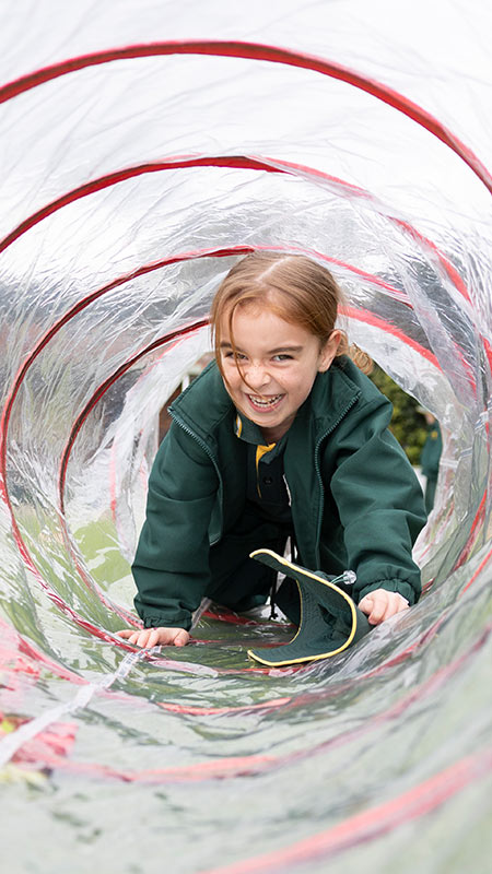 Our Lady of the Way Primary School, Emu Plains student crawling through play tunnel.