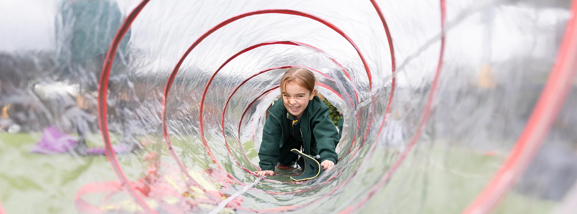 Our Lady of the Way Primary School, Emu Plains student crawling through play tunnel.